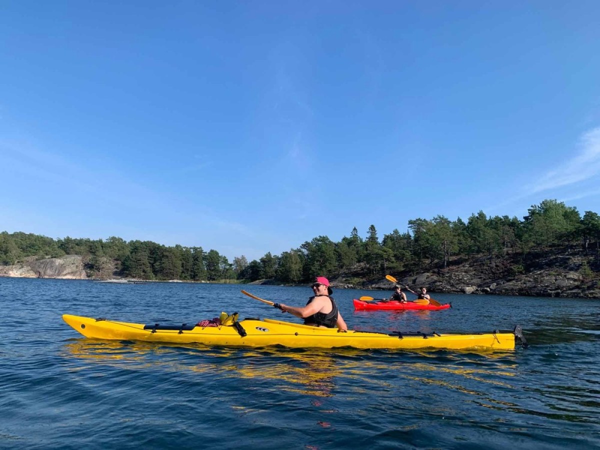 a group of people in a small boat in a body of water