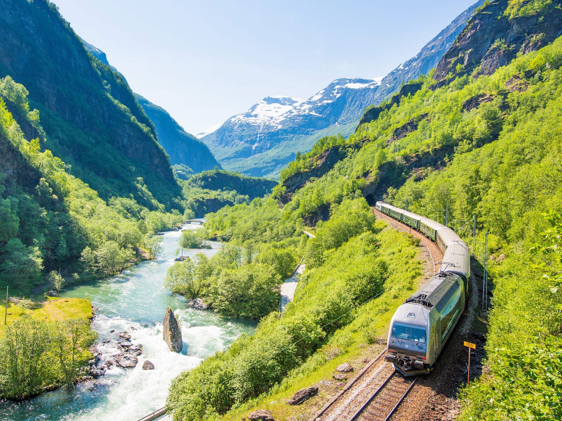 a train is parked on the side of a mountain